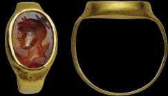 A roman carnelian intaglio, mounted on an ancient gold ring. Bust of Artemis. The goddess is turned to the left and has the quiver on her back. 2nd ce...