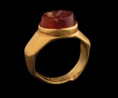 A roman carnelian intaglio, mounted in an ancient gold ring. Quadruped. Light ancient burn on the field and light wear marks. 3rd century A.D.
Intagl...