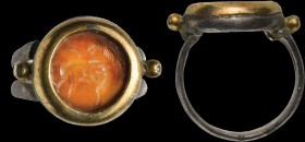 A roman carnelian intaglio mounted in a ring made of two metals. Two fighting puttos. One succeeds in overpowering the other with his right arm, block...