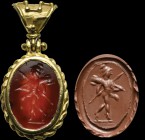 A roman carnelian intaglio, mounted in a modern gold pendant. Gradivus Mars. The god of war is moving to the left, carrying a trophy on his shoulders ...