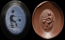 A roman nicolo intaglio. Satyr. The character is sitting on rocks, holding a bunch of grapes with his left hand, and the pedum with the right one. 2nd...