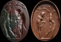A roman heliotrope intaglio. A shepherd (wearing a fur coat), leaning on a stick, watches his dog rushing on a hare, which is hanging from a tree. Int...