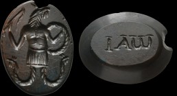 A magic, roman intaglio in brown jasper, with green shades. Anguipes cock. The figure is turned to the right, holding the solar whip in its right hand...