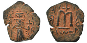 Arab Byzantine. Umayyad Caliphate, circa AD 641-660. Fals (bronze, 2.87 g, 21 mm). Pseudo-Byzantine type, imitating the types of Constans II. Standing...
