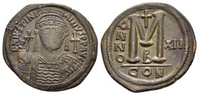 JUSTINIAN I.(527-565).Constantinople.Follis.

Obv : D N IVSTINIANVS P P AVC.
Helmeted, cuirassed bust facing, holding cross on globe and shield with h...