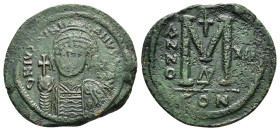 JUSTINIAN I.(527-565).Constantinople.Follis.

Obv : D N IVSTINIANVS P P AVC.
Helmeted, cuirassed bust facing, holding cross on globe and shield with h...