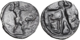 Greek Italy. Bruttium, Kaulonia. AR Stater, 475-470 BC. Obv. Apollo striding right, brandishing branch with right hand, small daimon on the extended l...