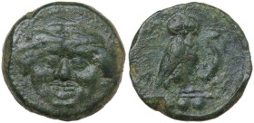 Sicily. Kamarina. AE Tetras, 425-405 BC. Obv. Gorgoneion facing. Rev. Owl standing left, head facing, wings closed, holding lizard; in exergue, three ...