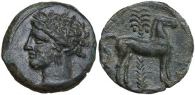 Punic Sicily. AE 15 mm, late 4th-early 3rd century BC. Obv. Head of Tanit left, wearing wreath of grain. Rev. Horse standing right before palm tree. S...