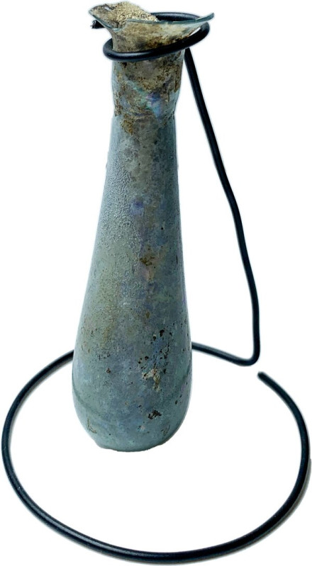 ROMAN GLASS UNGUENTARIUM Roman period, 1st-2nd century AD. Elongated unguentariu...