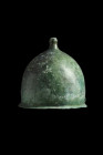 Ca. 1st century BC - 1st century AD.
A relatively light bronze legionary helmet with a bulbous domed bowl, small crest knob with a flattened top, pier...