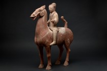 Ca. 202BC - 220AD.
An elegant hollow-moulded terracotta horse with a rider. This brown horse is modelled in a standing pose with its neck elegantly a...