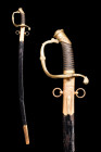 Ca. 19th century AD.
A sabre sword. This exquisite weapon is a stunning example featuring a curved fullered blade with a pointed tip. The hilt is a wo...