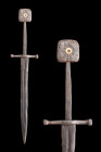 Ca. 1300 AD.
An iron dagger with a slender hand guard and a square pommel decorated with floral inlay. The cross-style two guard has a slight central ...