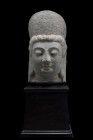 "Liao Dynasty, Ca. 907-1125 BC (or later).
A large schist head of Guanyin Buddha, carved with a small urna in the centre of the forehead, the face wi...