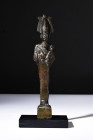 Late Dynastic Period, ca. 664-332 BC.
A bronze figure of Osiris in a mummiform position holding the crook and flail. He is depicted with a braided div...