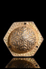 Ca. 300-400 AD.
A silver gilt phalera. Its form, a symphony of geometry, unveils a hexagonal shape that captivates the eye with its harmonious angles....