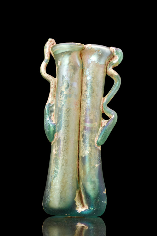Ca. 300 AD.
A beautiful double balsamarium crafted from greenish glass. The vess...