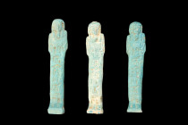 Late Period, 30th Dynasty, Ca. 332 BC.
A group of three light blue faience ushabti figures, each wearing a tripartite wig, a false beard, and with arm...