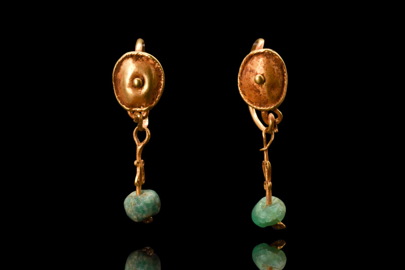 Ca. 100-200 AD.
A lovely pair of gold earrings comprised of a delicate hoop, sec...