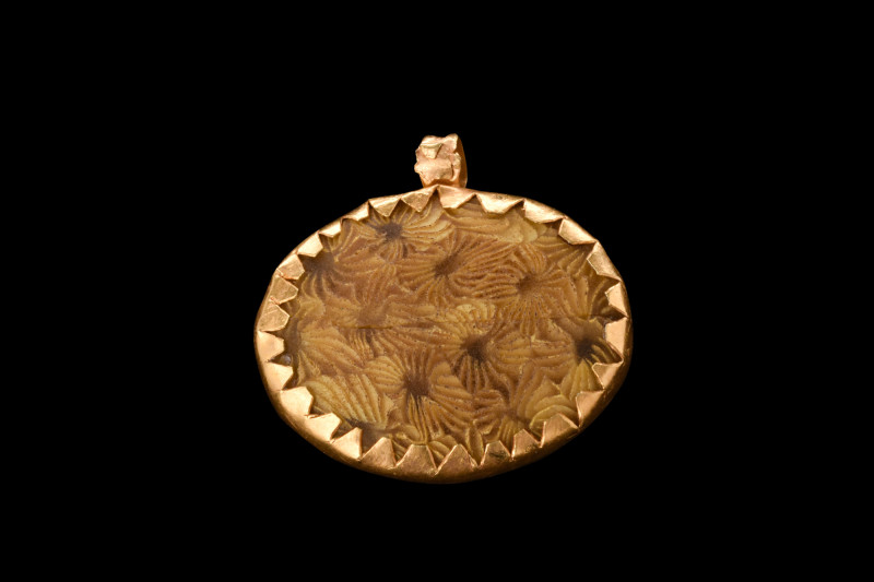 Ca. 400-300 BC.
An elegant pendant with an oval-shaped insert encased in a gold ...