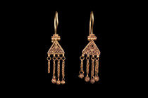 Ca. 600-700 AD.
A stunning matched pair of gold earrings. Each comprised of a hinged and elongated hoop attached to a triangular-shaped plaque with an...