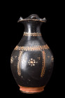 Ca. 325-300 BC.
A black-glazed pottery oinochoe boasts distinctive features that characterize this specific type of ancient Greek pottery. With a roun...