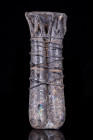 Ca. 200-300 AD.
A double-tube glass balsamarium with decorative applied trails around both rims and bodies in a deep blue tinge. It displays patches o...