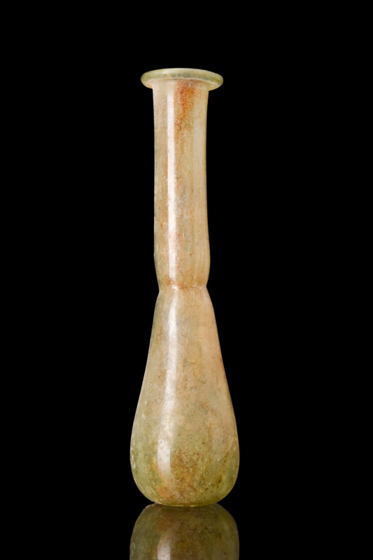 Ca. 1-300 AD.
A glass unguentarium featuring a piriform body with a constricted ...