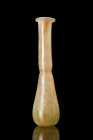 Ca. 1-300 AD.
A glass unguentarium featuring a piriform body with a constricted neck that culminates in a rounded rim. Glass production in the Roman w...