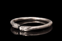 Ca. 4th-3rd century AD.
Crafted from silver, this bracelet follows the penannular design, featuring a round-section shank that gracefully encircles th...