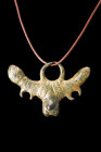 Ca. 200 AD.
A bronze phallic pendant features a central depiction of a phallus, accompanied by intricately rendered testicles, symbolizing potency and...