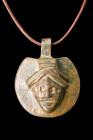 Ca. 100-300 AD.
Crafted from bronze, this pendant features a nearly circular shape with a suspension loop at the top, allowing it to be worn as a pers...