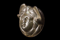 Ca. 100-200 AD.
A hollow bronze phalera adorned with a relief face of Medusa, a mythological figure of ancient Greek and Roman lore. Medusa, known for...