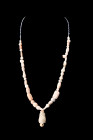 Ca. 100-300 AD.
A stone beaded necklace, composed of variously shaped beads, showcases a captivating arrangement of warm cream and beige hues. Each be...