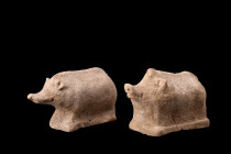 Ca. 400-300 BC.
A pair of pottery boars. Each of these figurines displays simplified features and is attached to an integral flat base with a rectangu...