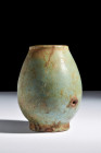 Late Period, ca. 664-332 BC.
A faience jar anchored upon a circular base. This vessel exudes a timeless allure – its globular body elegantly merges fo...