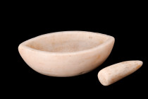 Ca. 700 BC.
A mortar and pestle skillfully fashioned from marble, features a boat-shaped body with a flat base, providing stability during the grindin...