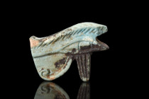 Late Period, ca. 664-332 BC.
A pale blue glazed faience amulet depicting the Eye of Horus with detailed modelling on both sides. The amulet is disting...