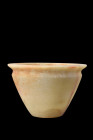 New Kingdom, ca. 1550-1070 BC.
An alabaster vessel featuring a conical-shaped body and circular flat base. The vessel showcases a graceful flaring tow...