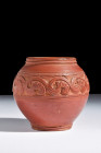 Ca. 300-400 AD.
A terra sigillata jar with a biconical form that reverberates with understated elegance, this vessel rests upon a low circular foot, i...