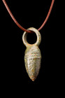 Ca. 100-300 AD.
Constructed from bronze, this pendant exhibits a distinct acorn shape, characterized by a pointed finial and a domed cupule adorned wi...
