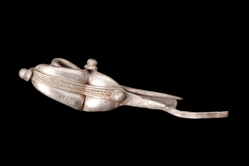 Ca. 6th-4th century BC.
A silver fibula, featuring a double-arched bow with cent...