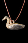 Ca. 100-300 AD.
A bronze pendant fashioned in the likeness of a duck. The pendant portrays the bird with a slender body, a gracefully curved S-shaped ...