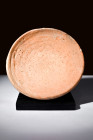 Ca. 100-300 AD.
A redware plate boasts an expansive rounded form, its contours harmoniously transitioning atop a dignified short foot. An air of timel...
