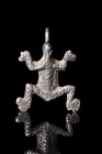 Ca. 300-100 BC.
A silver amulet fashioned in the likeness of a frog. Its form is elegantly etched into a flat-sectioned tableau. The amphibian's splay...