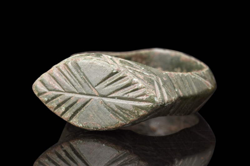 Ca. 100-300 AD.
A bronze finger ring featuring a round hoop, exhibiting a slight...