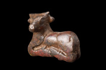 Ca. 100-300 AD.
A bronze bull figurine depicts the animal in a resting position, with all four legs gracefully folded beneath its body. Each leg is me...