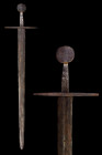 Ca. 1025-1380 AD.
A stunning iron sword Oakshott type ‘G’, with a wide blade almost parallel, then tapers down to a sharpish point. The blade is doubl...