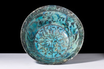 Ca. 1200 AD.
A pottery bowl with a truncated conical form, elevated foot, and flaring sides combine to create an aesthetically pleasing silhouette tha...